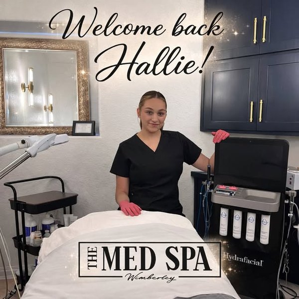 Hallie Strange beside the HydraFacial machine in a treatment room